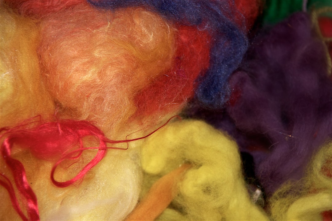 Close-up of a large, messy knot of multi-colored yarn, visually representing the chaos and unresolved issues in a communit...