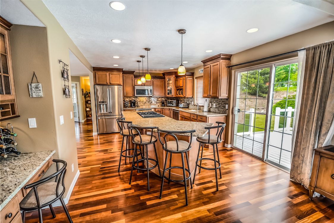Professional host warmly hands keys to a smiling guest at the entrance of a modern, stylish short-term rental property, re...