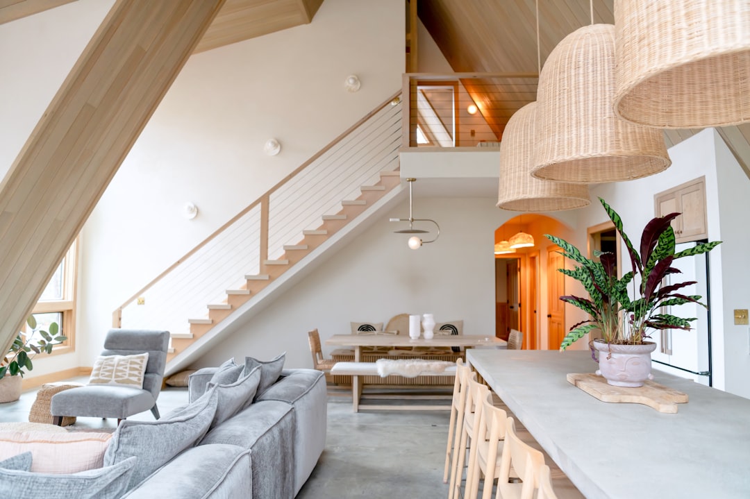 The sunlit interior of a beautiful, modern coastal vacation rental, showcasing the high-quality and seamless guest experience a digital portal provides.