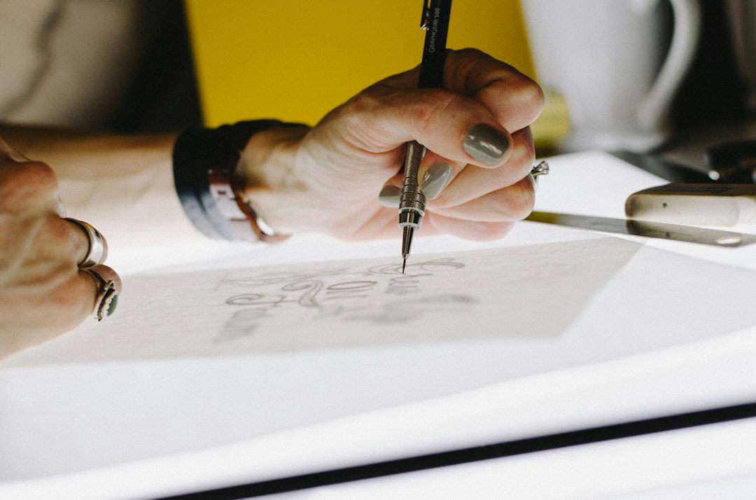 Homeowner sits at a bright, modern desk, carefully reviewing real estate documents with a pen and calculator nearby, symbo...